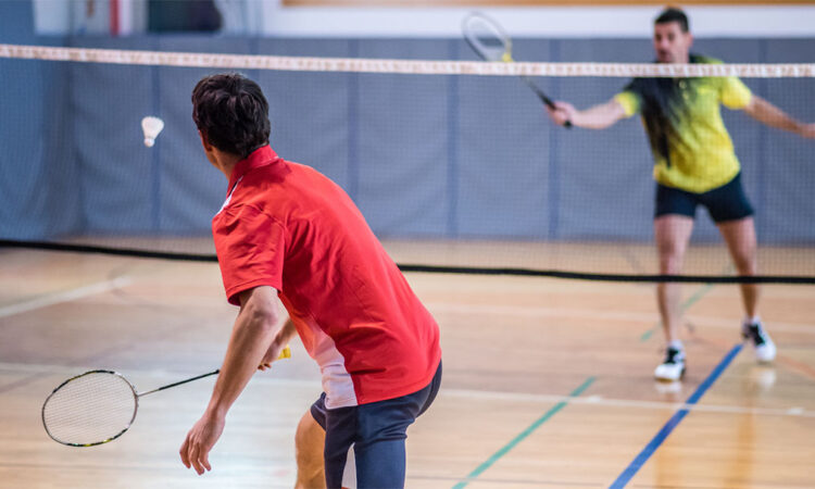 Two men playing badminton