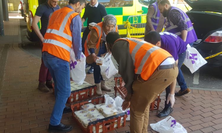Finsbury Park Mosque members give out food to staff at the Whittington