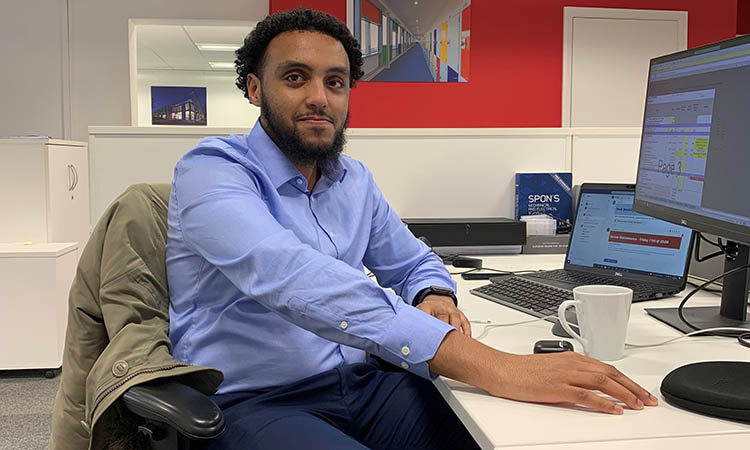 Mohamed sat infront of a computer