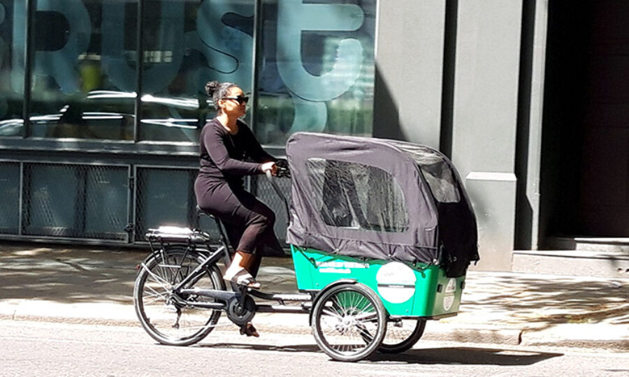 Person cycling with an Our Bike cargo bike