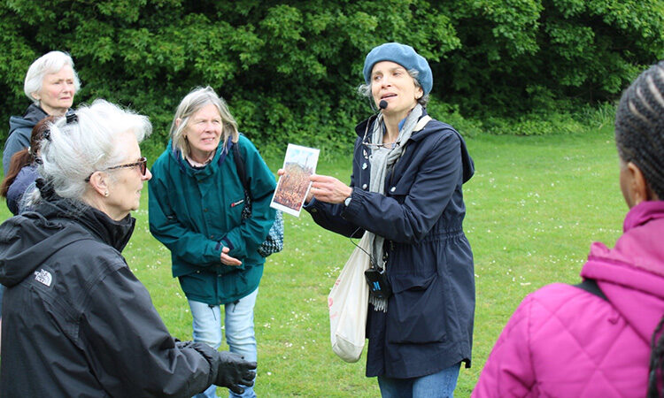 A person taking a group of older adults on a guided dementia walk
