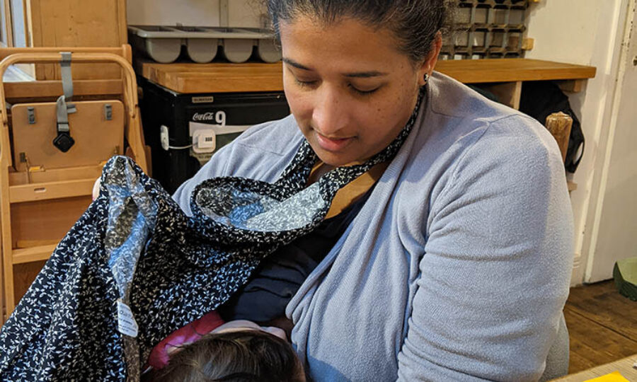 Mayani breastfeeding her child in a restaurant