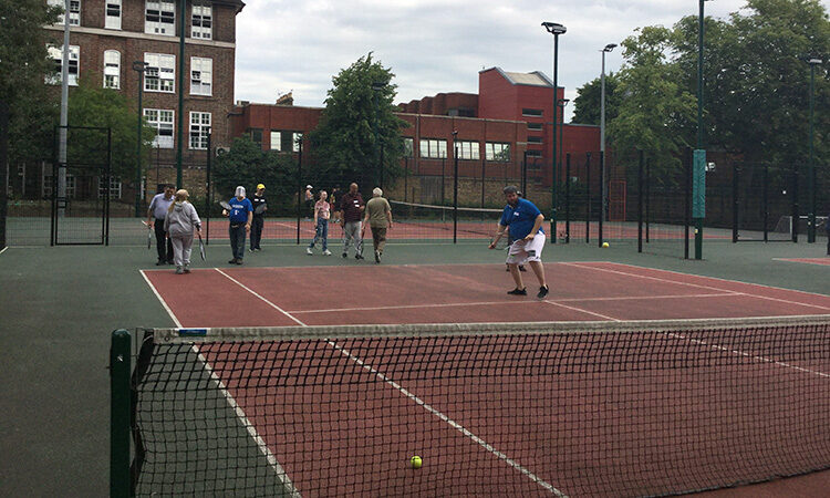 A group of people playing tennis