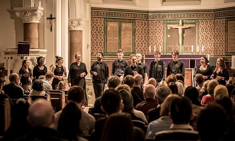Finsbury Park Singers performing infront of an audience in a church