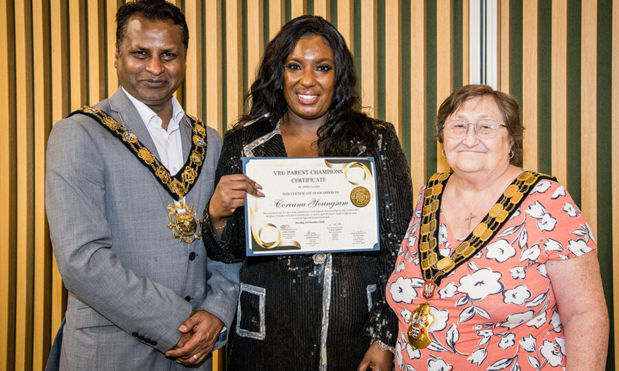 Parent champion Coreana with the mayor of Islington and another, holding a certificate