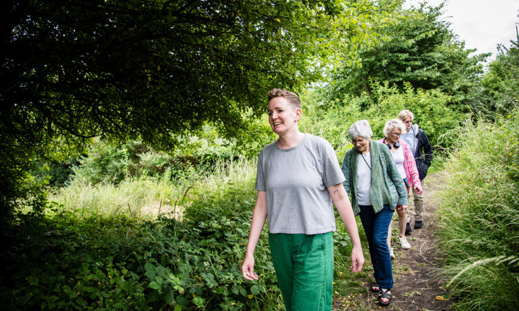 Jo Corrall leading four older adults on a walk through Gillespie Park