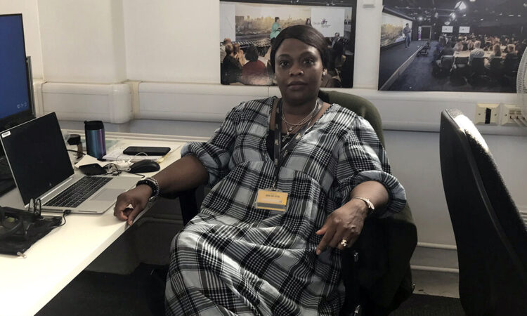 Funke Imiruaye, employer engagement officer in Islington Council’s iWork team, sat at a desk with a computer, facing the camera