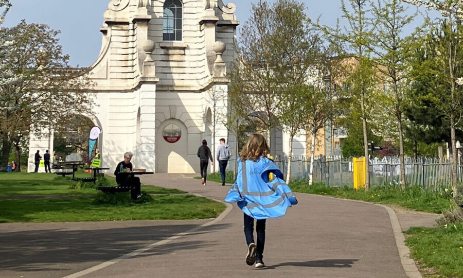 Young girl running on a path towards Cally Clock Tower