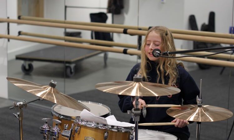 Adelaide, a girl playing the drums at Music Education Islington