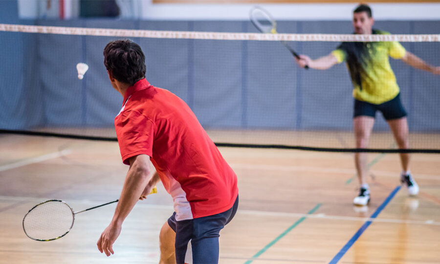 Two men playing badminton