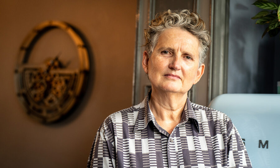 Head and shoulders shot of architect Alice Brown, a white lady with short grey curly hair