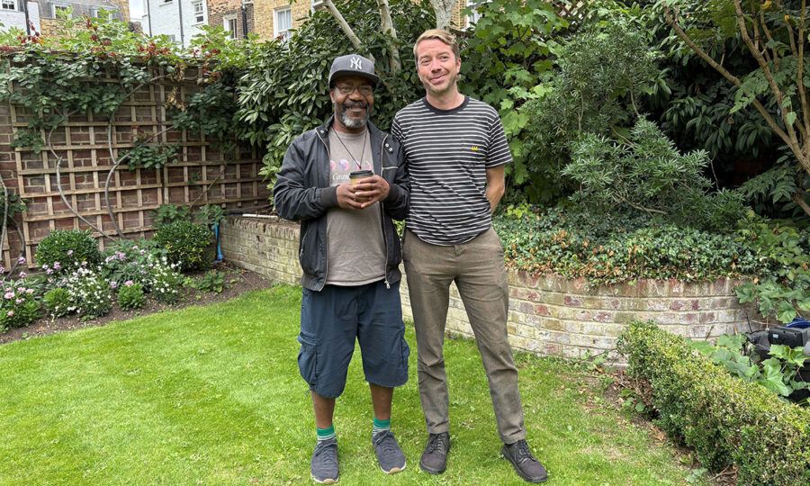 Service manager Gareth and service user Joseph stood together in the gardens at St Joseph's Hospice