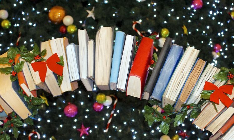 Festive book graphic with a stack of books and baubles around