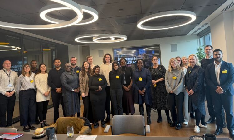 Group of people in a conference room smiling at the camera