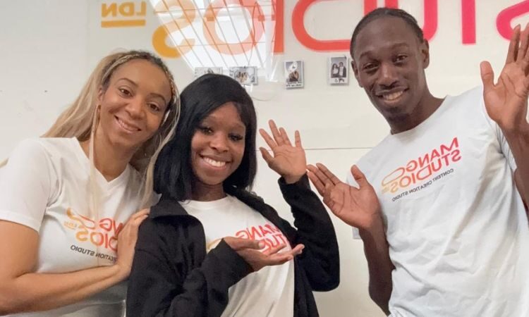 Three young people smiling at the camera