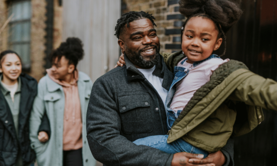Dad carrying daughter in the city