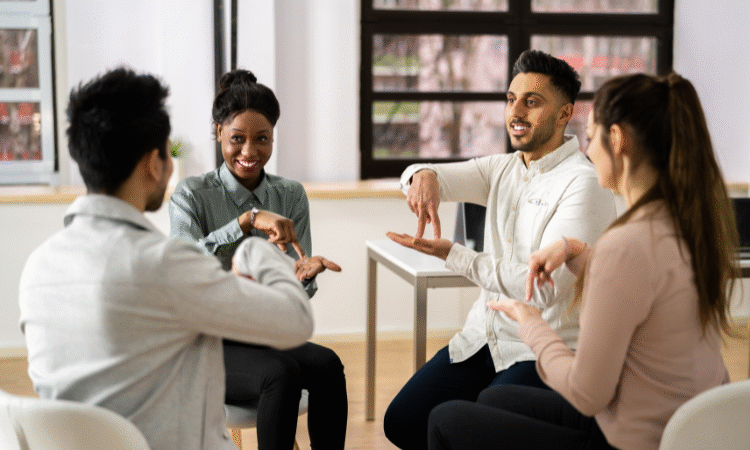 Group of diverse people signing using British Sign Language