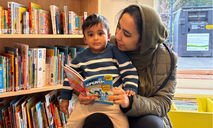 A mother reading to her child in the library